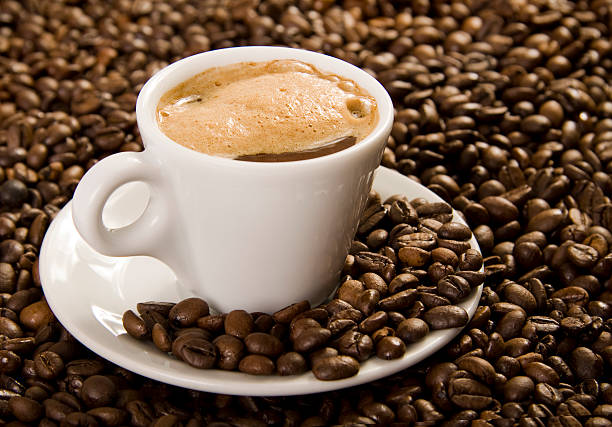 Cup of coffee on coffee beans